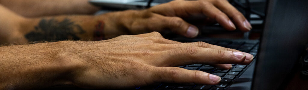 U.S. Marine cyberspace warfare operator working at a computer workstation during a network defense exercise in Okinawa, Japan.