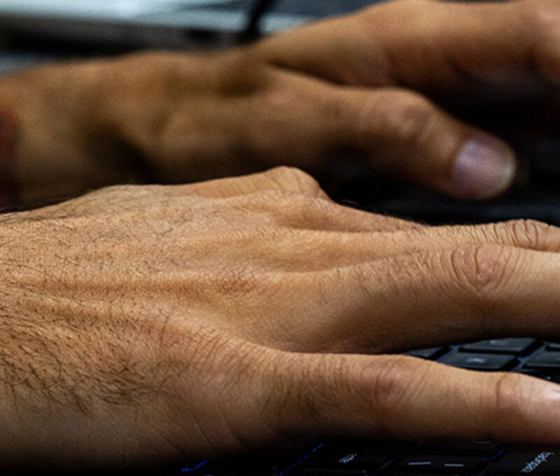 U.S. Marine cyberspace warfare operator working at a computer workstation during a network defense exercise in Okinawa, Japan.